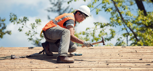 Construction worker performing roof repairs